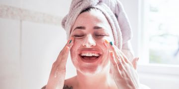 Applying the facewash and cream to fight against skin disorders