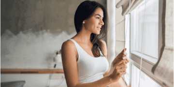 Girl standing near window